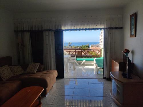 a living room with a couch and a view of the ocean at Victoria Court 2, Los Cristianos in El Guincho