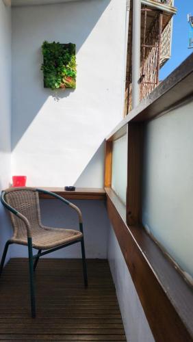 a chair sitting on top of a balcony at 車站100m民宿丨電梯附停車場 in Hualien City