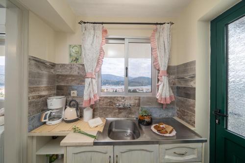 A kitchen or kitchenette at Aphrodite Superb Sea View Apartment