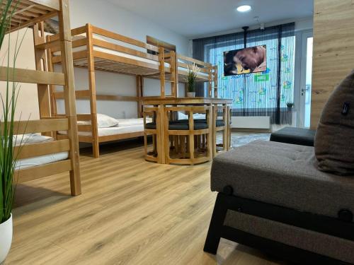 a room with two bunk beds and a couch at Ferienwohnung in Center of Hamburg-Barmbek-Airport-4 in Hamburg