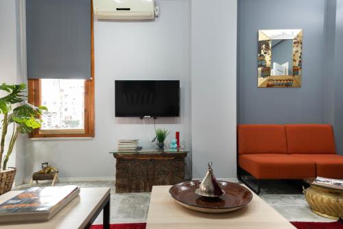 a living room with a couch and a tv at La Villa Gardenia : 4Br Villa with Private Garden in Istanbul