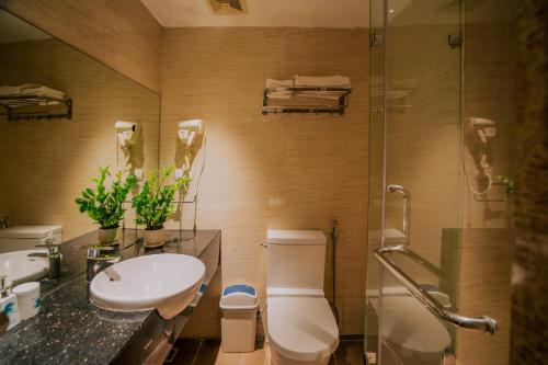 a bathroom with a toilet and a sink and a shower at Hanoi Center Silk Classic Hotel & Travel in Hanoi