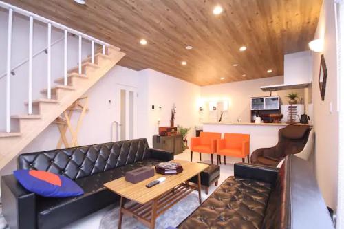 a living room with a couch and a table at Fuji Time Traveler 玉手箱 in Fujikawaguchiko