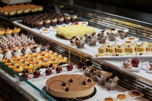 a display case filled with different types of desserts at Esperos Mare Resort & Spa in Faliraki