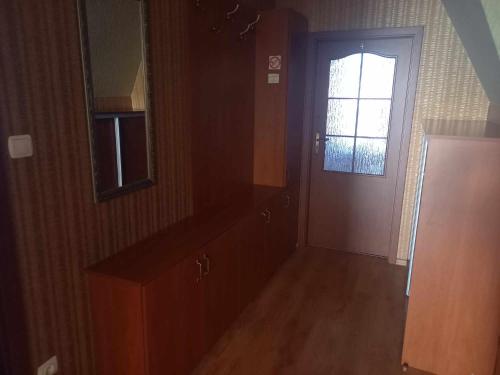 an empty kitchen with a door and a window at Miltex in Torzym