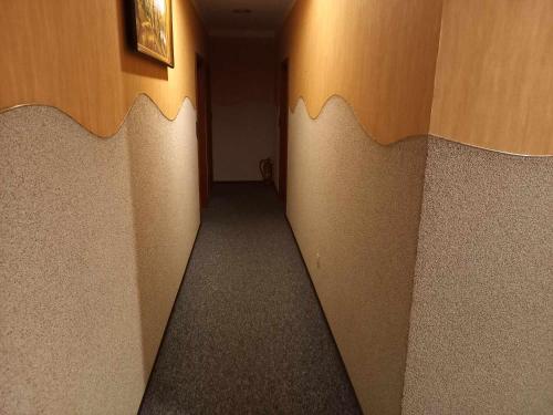 a hallway of a room with brown walls and a hallway at Miltex in Torzym