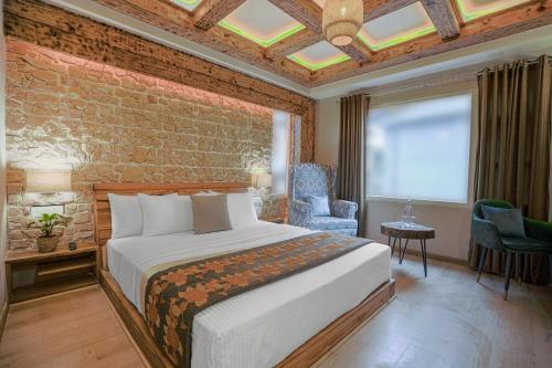 a bedroom with a bed and a brick wall at Saanjh - The Musical Sunset in Shimla