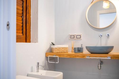a bathroom with a sink and a mirror at Le Tartane B&b Guidaloca in Castellammare del Golfo