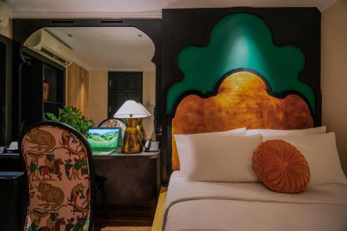 a bedroom with a bed with a wooden headboard at Hanoi Center Silk Classic Hotel & Travel in Hanoi