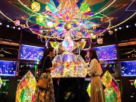 two women standing in front of a display of lights at Zentsuji Grand Hotel in Zentsuji
