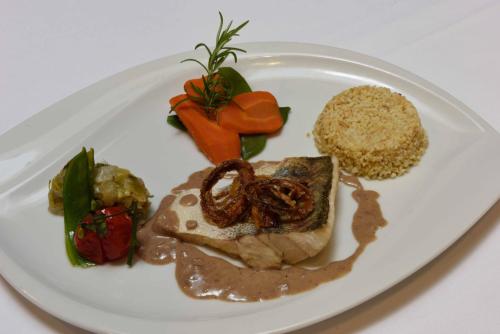 a plate of food with meat and vegetables on it at Le Saint Sébastien in Blendecques