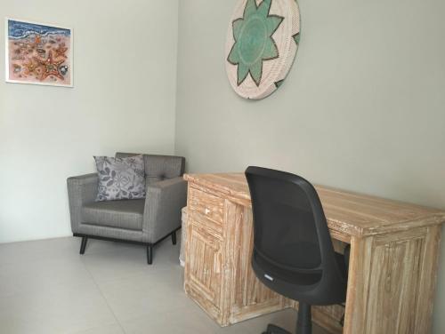 a desk and a chair in a room at Pandan Villas in Selong Belanak