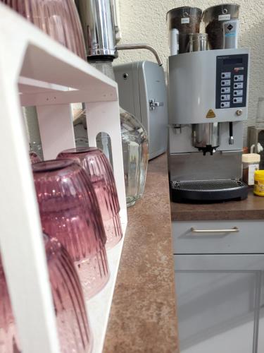 a kitchen with wine glasses on a counter at Pension Turm in Schönwald