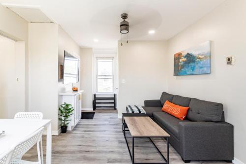 a living room with a couch and a table at Full modern 1Bdr Apt w/ Private Entrance on 2nd FL in Bethpage