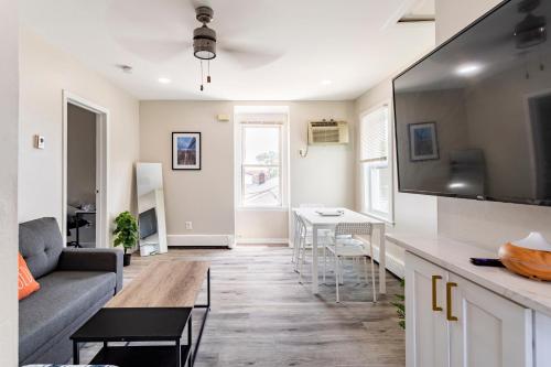 a living room with a couch and a table at Full modern 1Bdr Apt w/ Private Entrance on 2nd FL in Bethpage