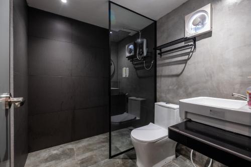 a bathroom with a toilet and a sink and a shower at Boutique Hidden loft in Bukit Mertajam