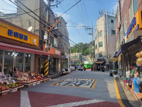 an empty street in a city with buildings at Cozy Private Home Newly Renovated in Seoul