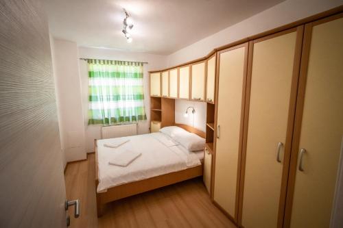 a small room with a bed and a window at Apartment Gracia 1 in Baška
