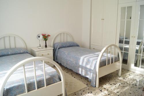 En eller flere senge i et værelse på Il Melograno