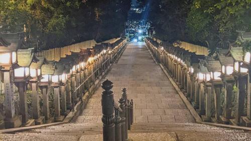 an empty aisle with lights on it at night at Kanko Ryokan Yamato in Ikuma