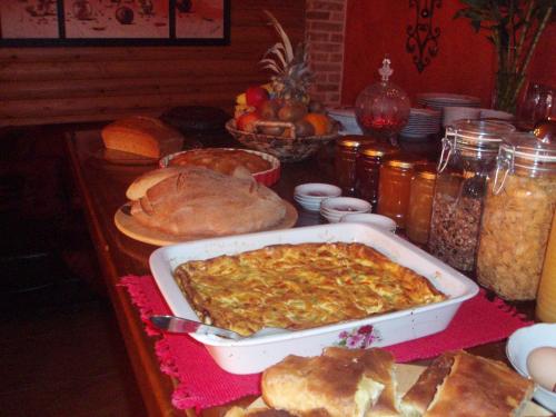 a table with a dish of food and bread at Enthymio Suites in Synikia Mesi Trikalon