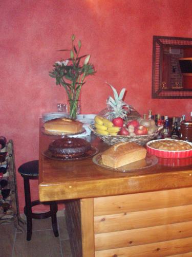 a table with a bunch of bread and fruit on it at Enthymio Suites in Synikia Mesi Trikalon