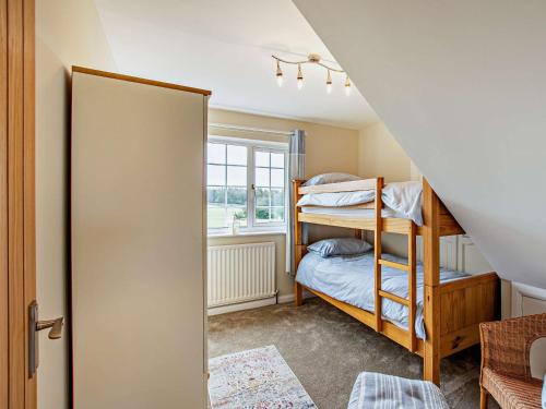 a bedroom with bunk beds and a window at 3 Bed in Cockermouth 90920 in Tallentire