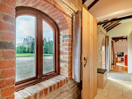 a brick wall with a window in a hallway at 2 Bed in Digby 91059 in Ashby de la Launde