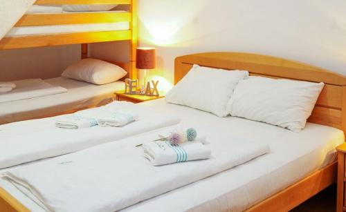 two beds in a hotel room with towels on them at Eko-FIS Vlašić in Vlasic