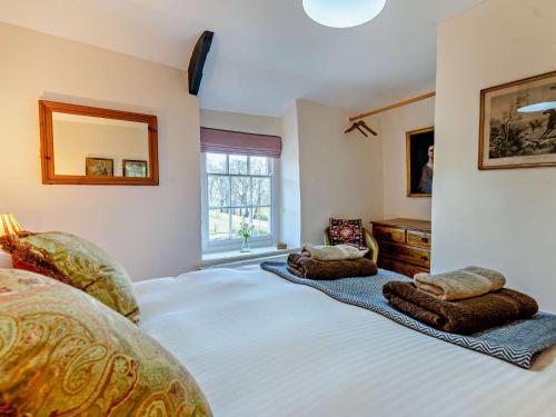 a bedroom with a large bed with two pillows on it at 3 Bed in Llanover 91241 in Llanover
