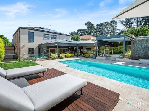 a swimming pool in the backyard of a house at Luxury Family Holiday Rental On the Mornington Peninsula in Frankston South