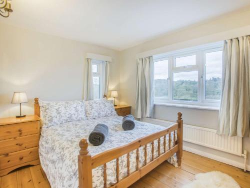 a bedroom with a bed and a window at 3 Bed in Weare Giffard 90864 in Weare Giffard