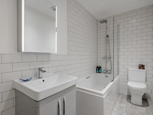 a white bathroom with a sink and a toilet at 3 Bed in Comrie 90794 in Comrie