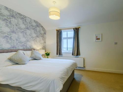 a bedroom with a white bed and a window at 1 Bed in Holmfirth 91106 in Cartworth