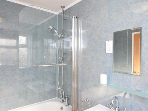 a bathroom with a shower with a tub and a sink at 2 Bed in New Romney 91126 in Greatstone