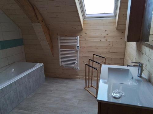 uma casa de banho com uma banheira e um lavatório em Grande maison 7 chambres em Cheylade
