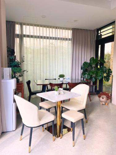 a dining room with white chairs and tables and a window at 花蓮壽豐 - Twinkle Night 星空說民宿A館 in Zhixue