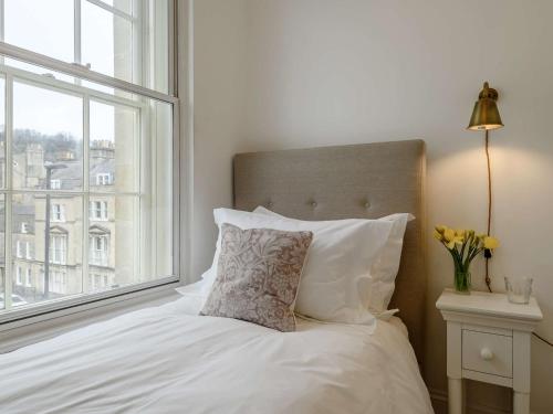 a white bed with a pillow and a window at 2 Bed in Bath 91066 in Bath