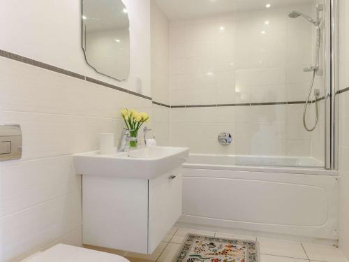 a white bathroom with a sink and a shower at 2 Bed in Bath 91066 in Bath