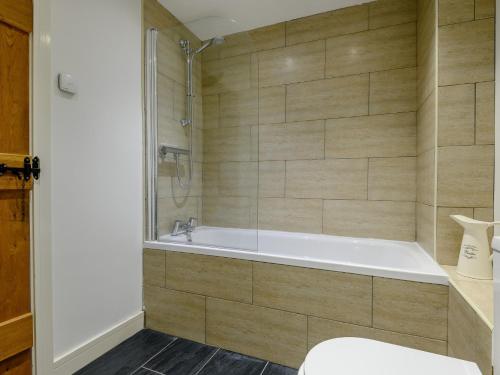 a bathroom with a tub and a toilet at 1 Bed in Castle Cary 91185 in Castle Cary