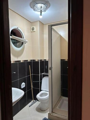 a bathroom with a toilet and a sink at Holikeys - El Jadida - 2 Ch - Sidi Bouzid 004 in El Jadida