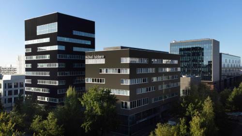 a tall black building in a city with trees at Best Western Plus Hôtel Isidore in Saint-Jacques-de-la-Lande