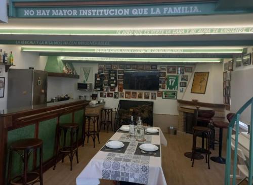 a restaurant with a table and chairs and a bar at El Txoko Andaluz in Cantillana