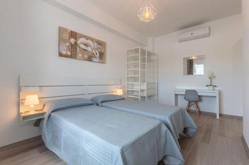 a bedroom with a blue bed and a desk at BO 40 SELF CHECK-IN - Appartamento Fiera-Tecnopolo in Bologna