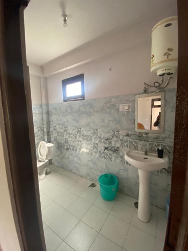 a bathroom with a sink and a toilet at Freedom Cafe in Kalgha