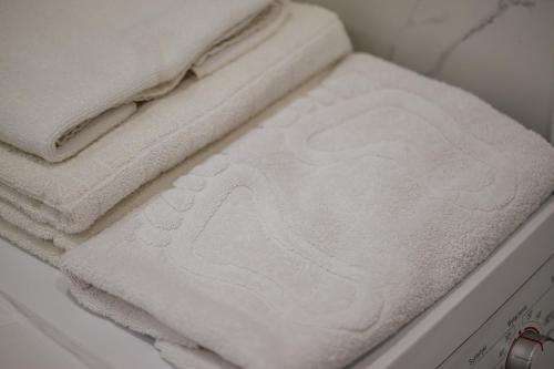 a stack of white towels sitting in a drawer at Luxury Apartments-Belochka in Uzhhorod
