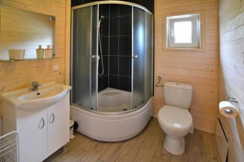 a bathroom with a shower and a toilet and a sink at Comfortable holiday home for 4 people Ustronie Morskie in Ustronie Morskie