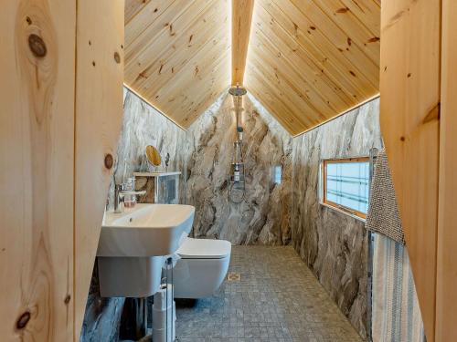 a bathroom with a sink and a toilet at 1 Bed in Biggar 91252 in Libberton