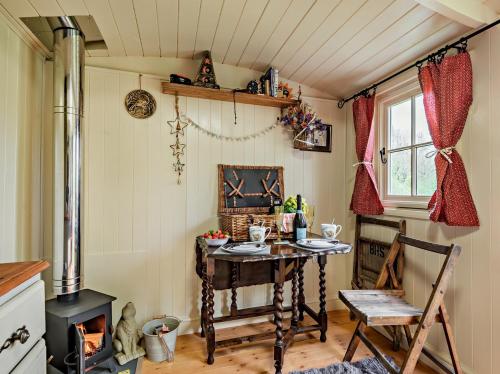 a small room with a table and a chair at 1 Bed in Coleford 91373 in Bream