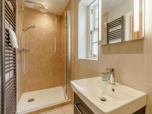 a white bathroom with a shower and a sink at 1 Bed in Osmotherley 91336 in Osmotherley